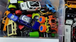 Box with car models of Jaguar, Nissan, Audi, Maserati, Peugeot, pickup truck, police, monster truck.